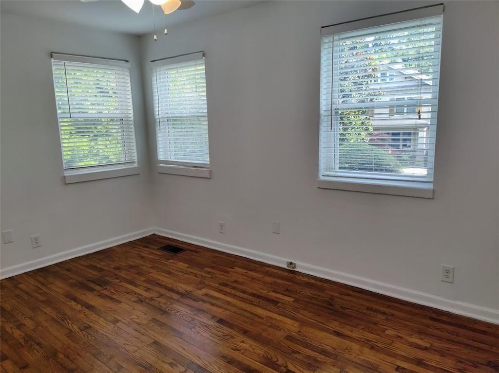 223 Sterling Street, Unit A Decatur, GA 30030 - Photo 17 of 36 a view of an empty room with wooden floor and a window