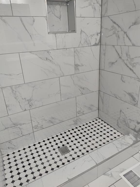 223 Sterling Street, Unit A Decatur, GA 30030 - Photo 19 of 36 a bathroom with a glass door