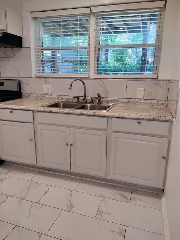 223 Sterling Street, Unit A Decatur, GA 30030 - Photo 23 of 36 a kitchen with granite countertop a sink and a white cabinets