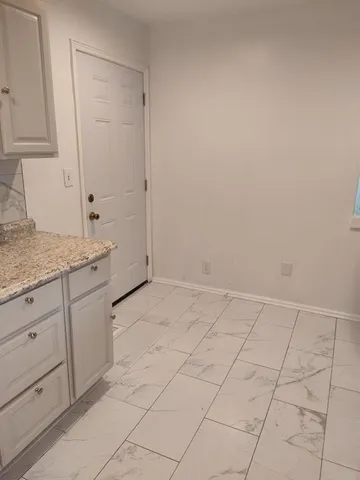 a stove top oven sitting inside of a kitchen