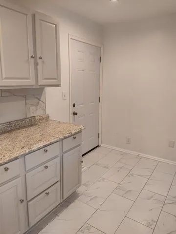 a kitchen with granite countertop cabinets and sink