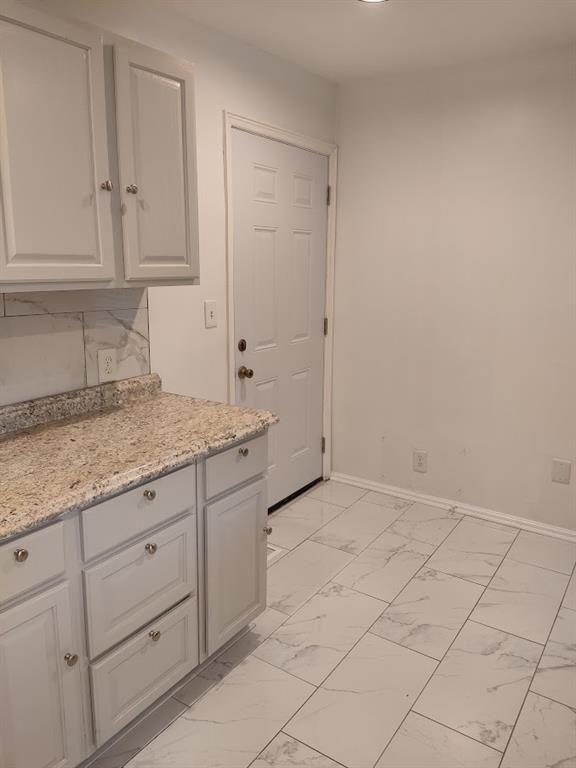 223 Sterling Street, Unit A Decatur, GA 30030 - Photo 29 of 36 a bathroom with a granite countertop sink and cabinets