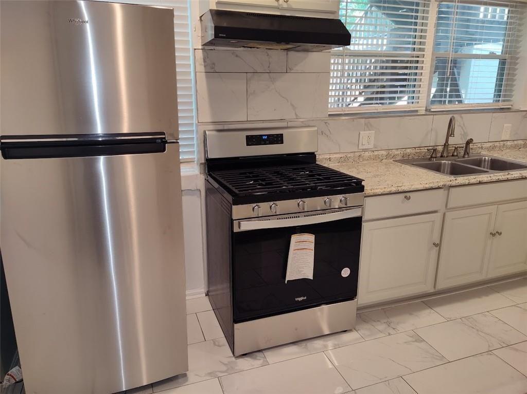 223 Sterling Street, Unit A Decatur, GA 30030 - Photo 30 of 36 a stove top oven sitting inside of a kitchen