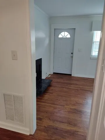 a view of a hallway with wooden floor