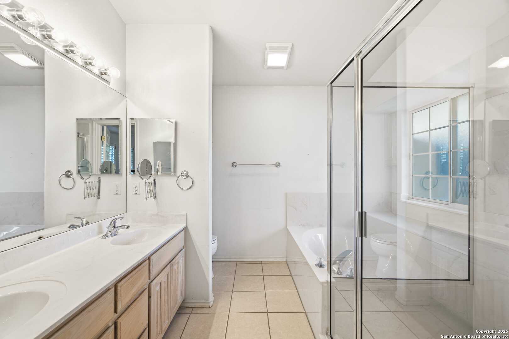 129 Los Cedros Loop Kerrville, TX 78028 - Photo 12 of 26 a bathroom with a double vanity sink and shower