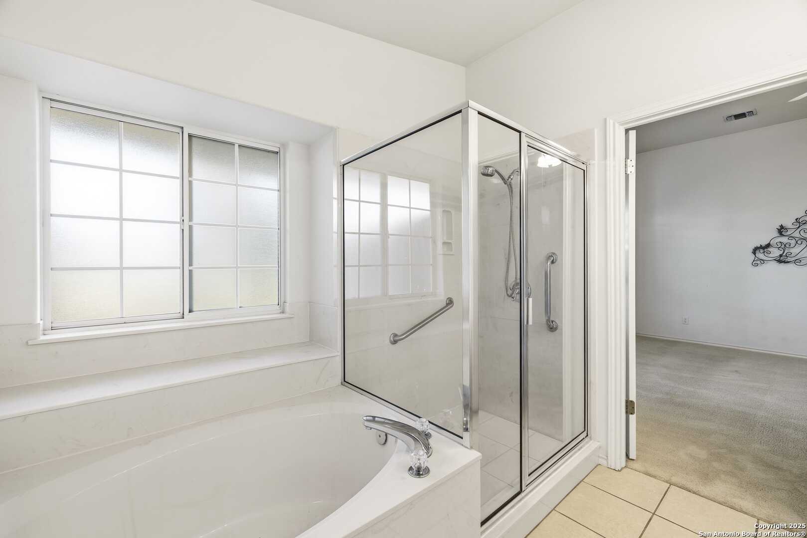 129 Los Cedros Loop Kerrville, TX 78028 - Photo 13 of 26 a bathroom with a bathtub and a shower