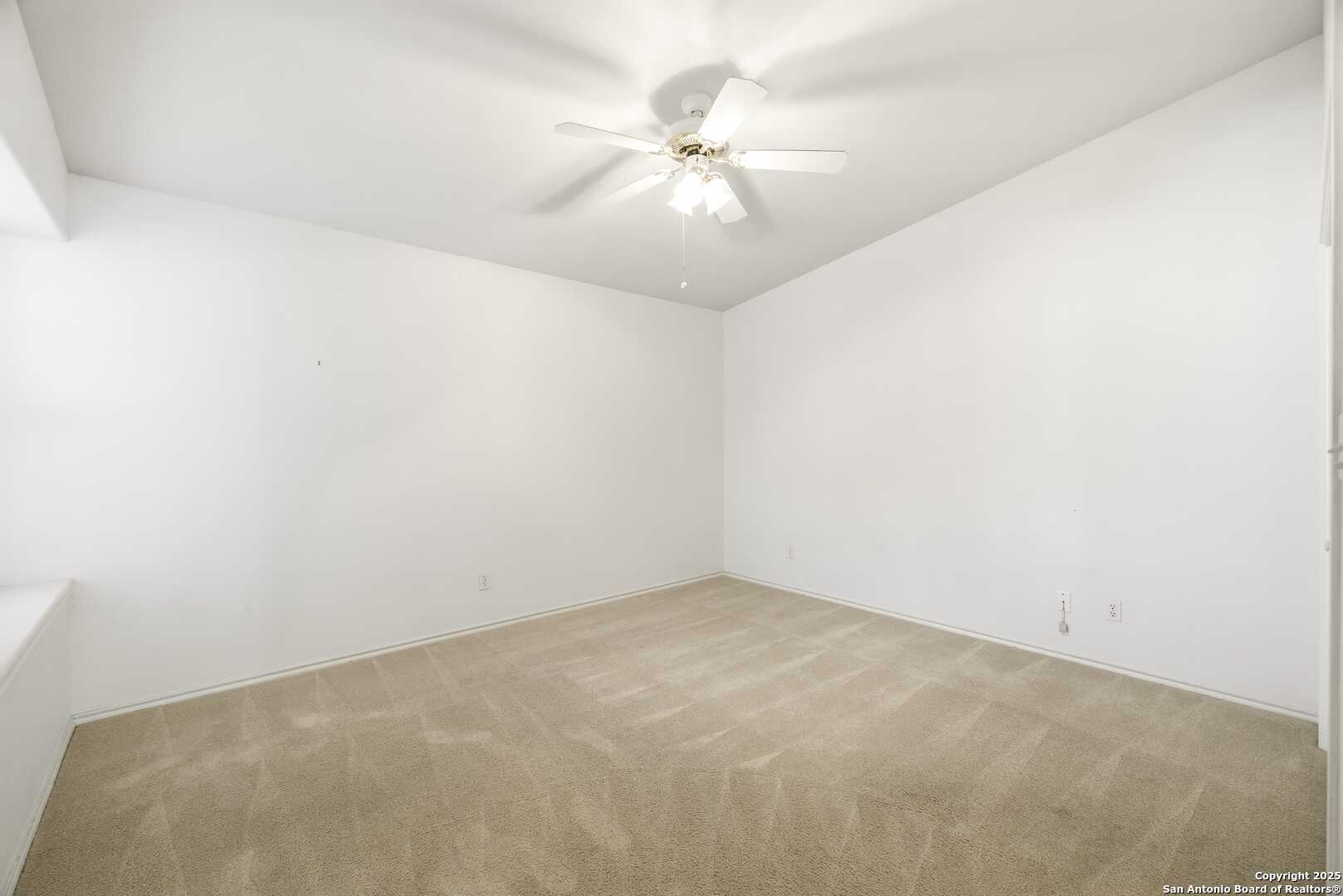 129 Los Cedros Loop Kerrville, TX 78028 - Photo 15 of 26 an empty room with a window and a ceiling fan