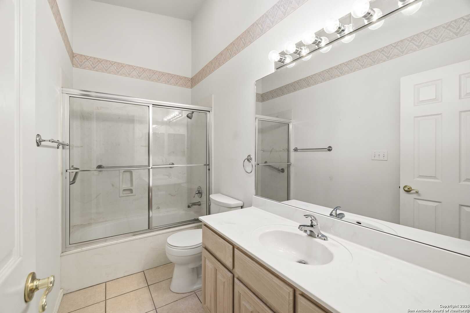 129 Los Cedros Loop Kerrville, TX 78028 - Photo 17 of 26 a bathroom with a shower sink vanity mirror and toilet
