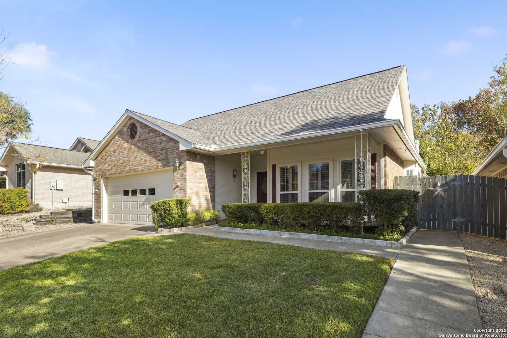129 Los Cedros Loop Kerrville, TX 78028 - Photo 2 of 26 a front view of a house with a yard