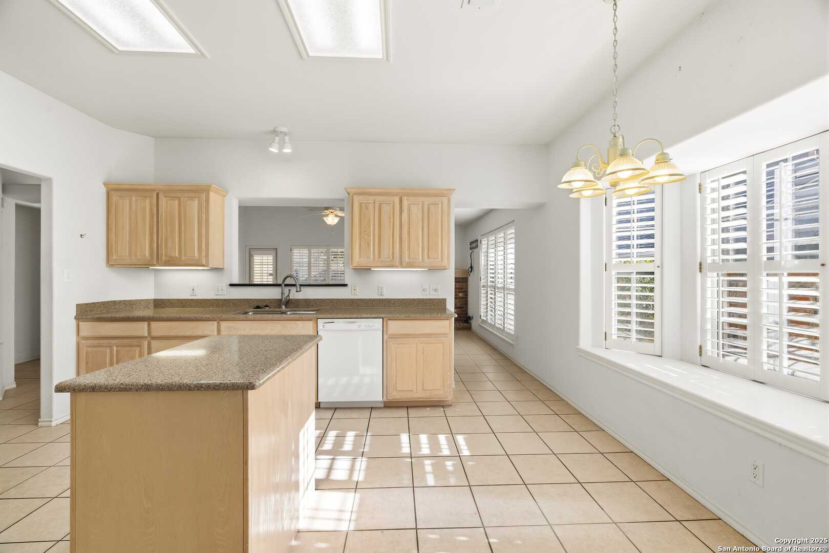 129 Los Cedros Loop Kerrville, TX 78028 - Photo 6 of 26 a kitchen with stainless steel appliances granite countertop a stove a sink and a refrigerator