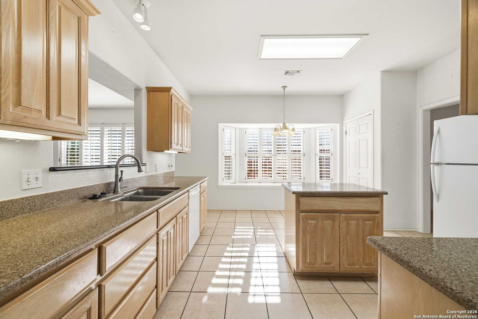 129 Los Cedros Loop Kerrville, TX 78028 - Photo 7 of 26 a kitchen with a sink stove and refrigerator