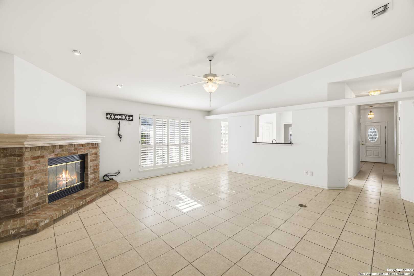 129 Los Cedros Loop Kerrville, TX 78028 - Photo 10 of 26 a view of an empty room with window and fire place