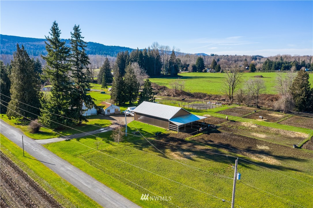 5651 Putnam Road Everson, WA 98247 - Photo 1 of 38 a view of a park with large trees and a wooden fence