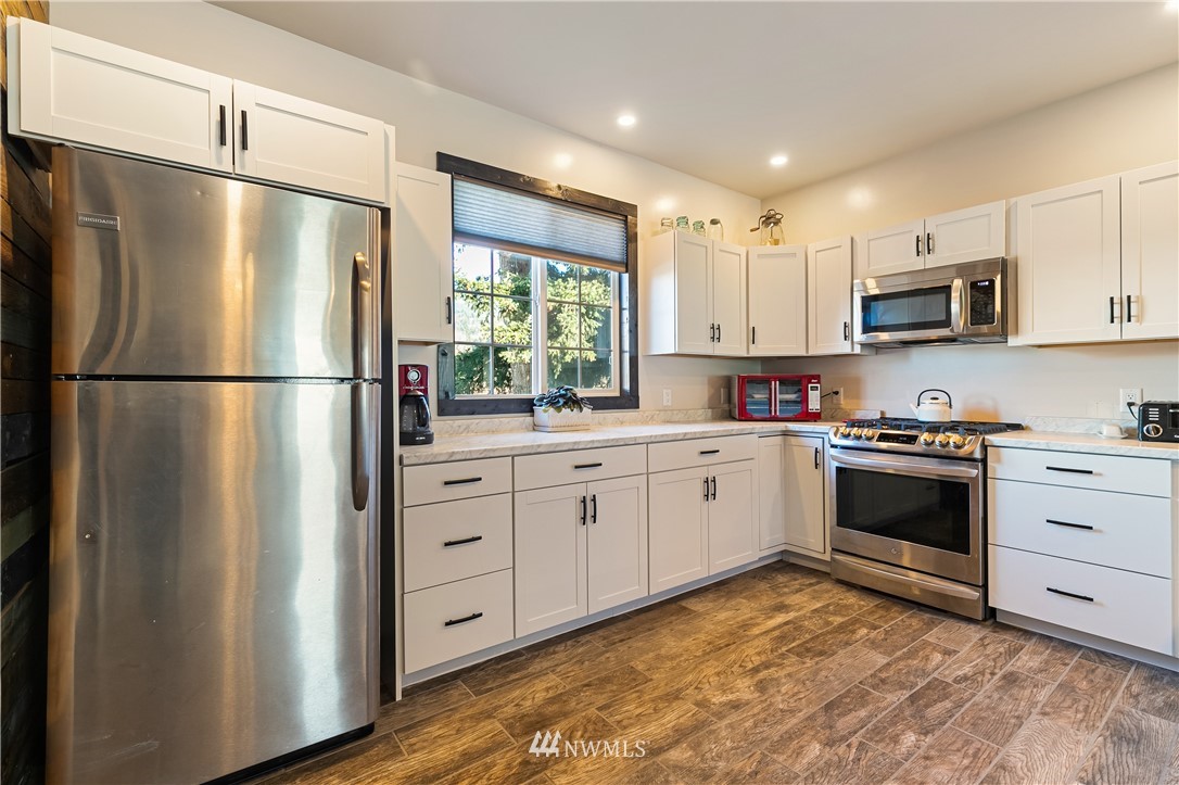 5651 Putnam Road Everson, WA 98247 - Photo 14 of 38 a kitchen with stainless steel appliances white cabinets and a refrigerator