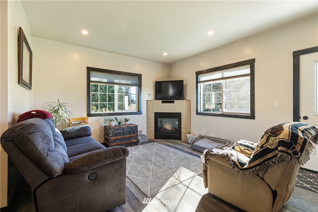 5651 Putnam Road Everson, WA 98247 - Photo 21 of 38 a living room with furniture window and a fireplace