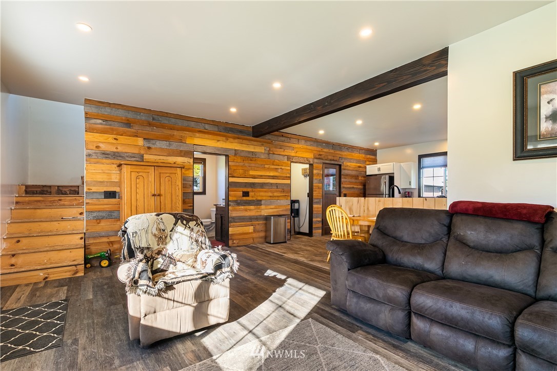 5651 Putnam Road Everson, WA 98247 - Photo 22 of 38 a living room with furniture kitchen view and a chandelier