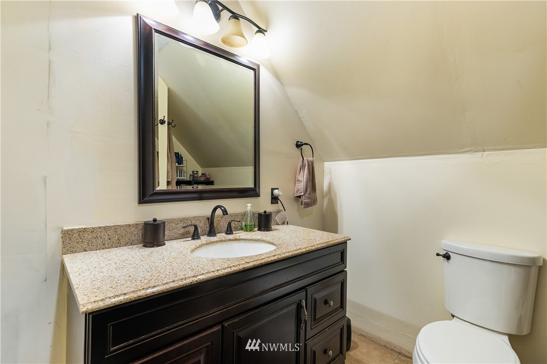 5651 Putnam Road Everson, WA 98247 - Photo 26 of 38 a bathroom with a granite countertop toilet sink and mirror