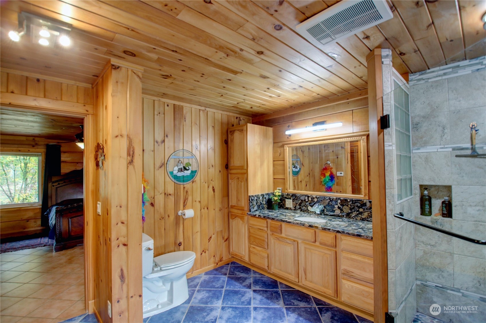 9363 Silver Lake Road Maple Falls, WA 98266 - Photo 19 of 38 a bathroom with a granite countertop sink a toilet and shower