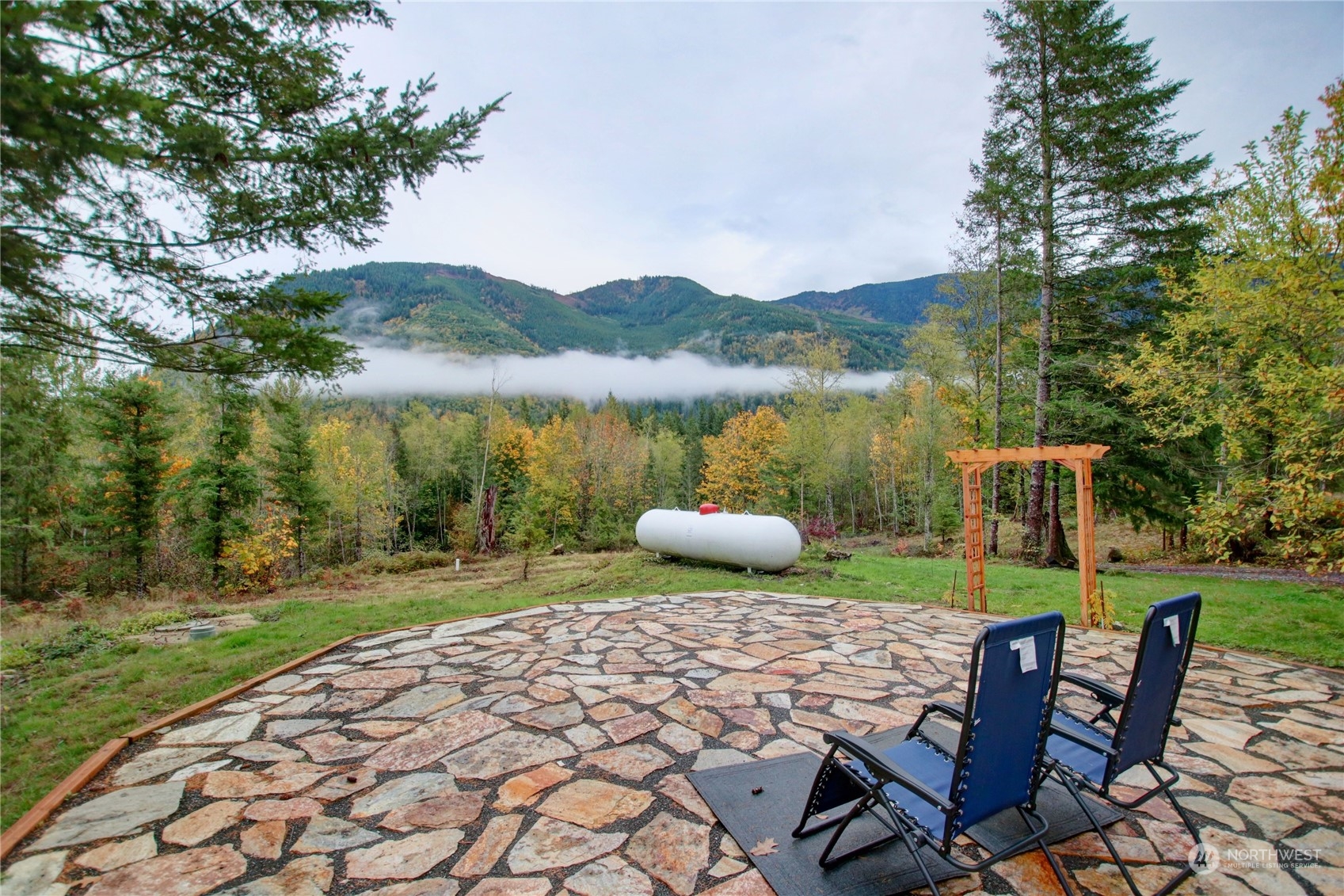 9363 Silver Lake Road Maple Falls, WA 98266 - Photo 6 of 38 a view of a lake with table and chairs next to a yard