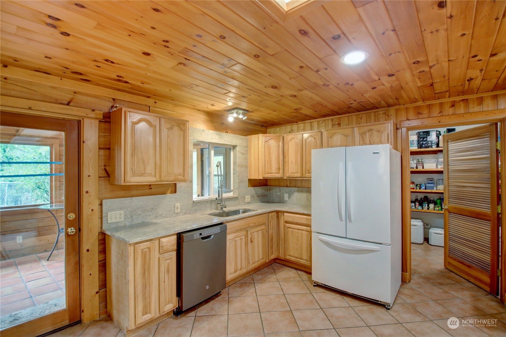 9363 Silver Lake Road Maple Falls, WA 98266 - Photo 9 of 38 a kitchen with a refrigerator sink and cabinets