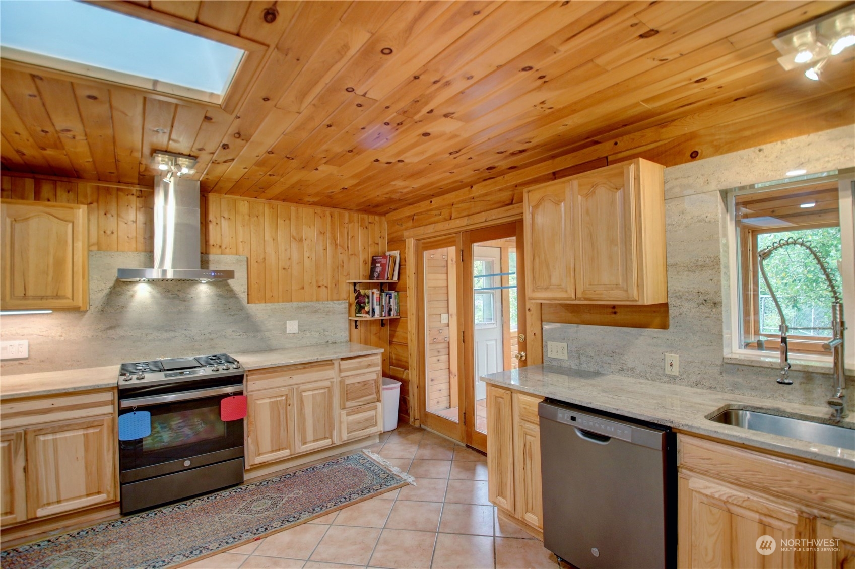 9363 Silver Lake Road Maple Falls, WA 98266 - Photo 10 of 38 a kitchen with stainless steel appliances granite countertop a sink a stove and a wooden floors