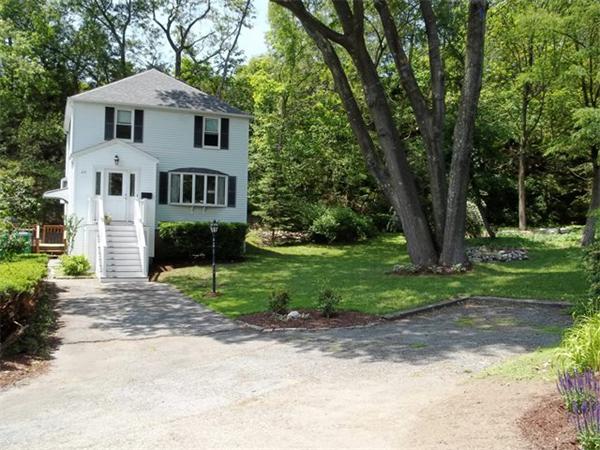 26 Fern Road Medford, MA 02155 - Photo 1 of 27 a white house with a yard and large trees