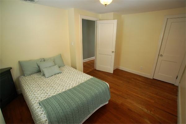 26 Fern Road Medford, MA 02155 - Photo 17 of 27 a bedroom with a bed and wooden floor