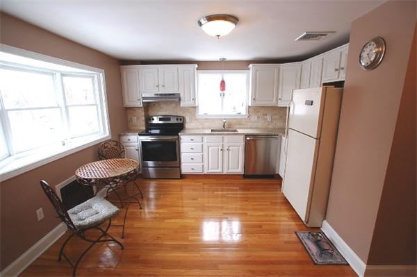 26 Fern Road Medford, MA 02155 - Photo 6 of 27 a kitchen with granite countertop a refrigerator and a stove top oven