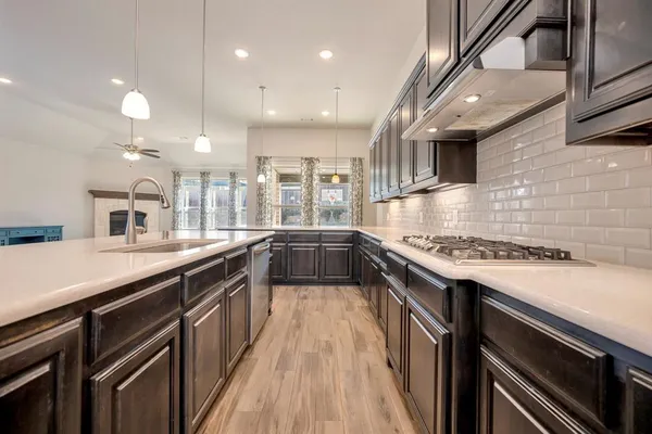a kitchen with stainless steel appliances granite countertop a refrigerator and cabinets