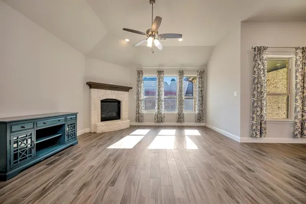 a kitchen with stainless steel appliances granite countertop a sink a stove and a wooden floors