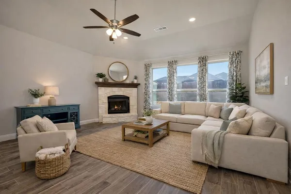 a living room with furniture and a fireplace