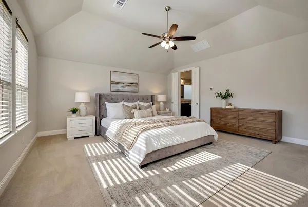 a bedroom with a large bed and a window