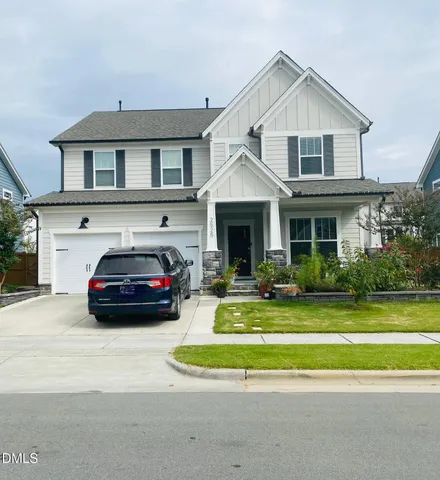 a view of a car parked in front of a house