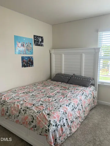 a bedroom with a bed and window