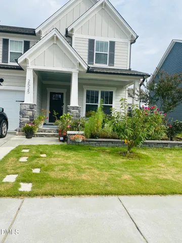 a front view of a house with swimming pool and sitting area
