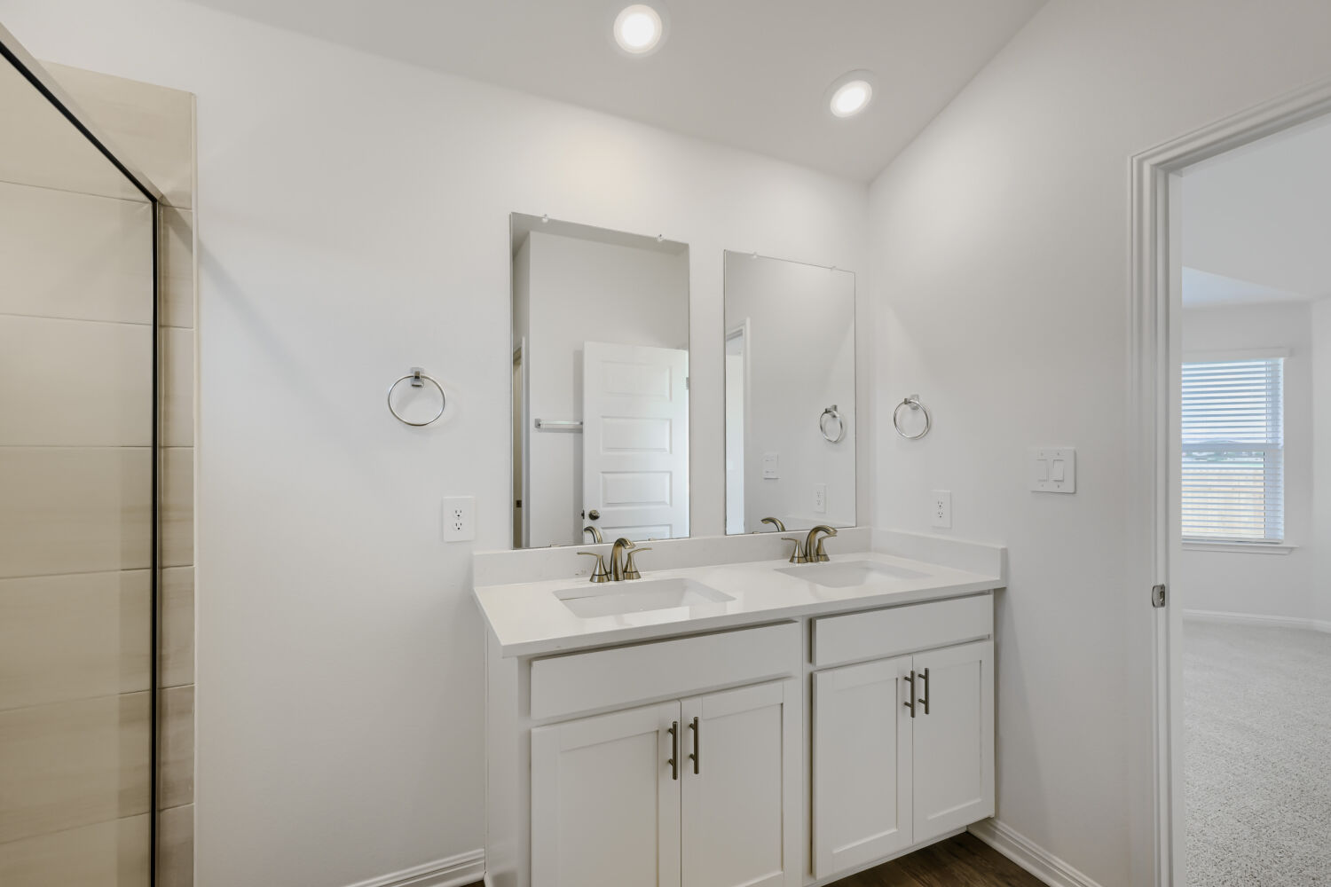 146 Diablo Rim Terrace Dripping Springs, TX 78620 - Photo 19 of 32 A well-lit primary bathroom featuring dual vanities and contemporary fixtures.