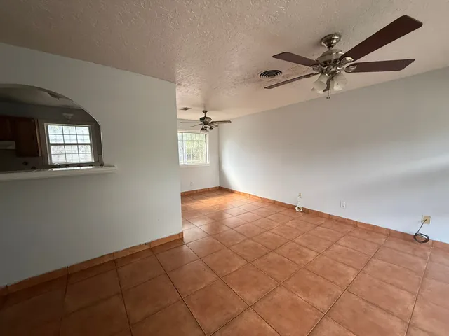 a view of a livingroom with a ceiling fan and window