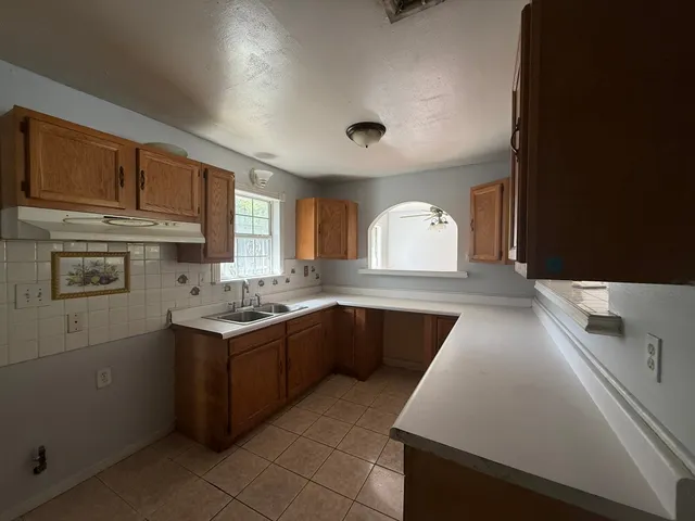 a kitchen with stainless steel appliances granite countertop a sink and stove
