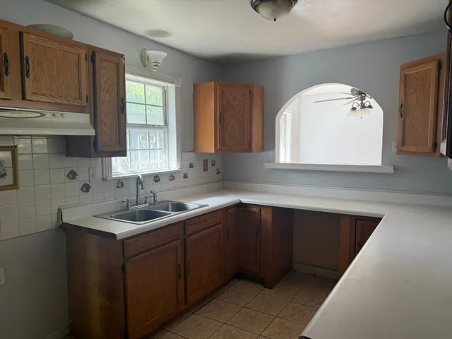 a kitchen with a sink and cabinets