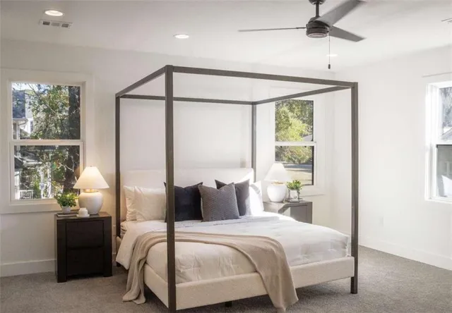 a bedroom with a large bed and a window