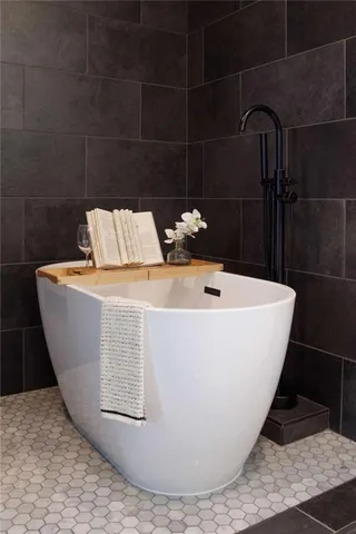 a white bath tub sitting in a bathroom