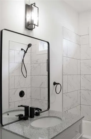 a bathroom with a shower and mirror