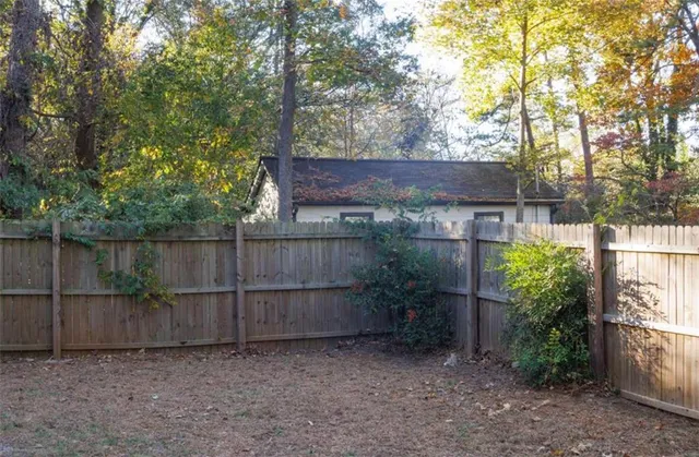 a view of a backyard with wooden fence