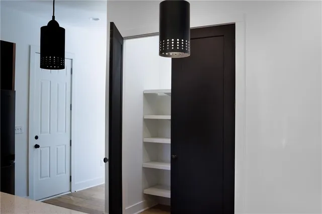 a close view of walk in closet with living room