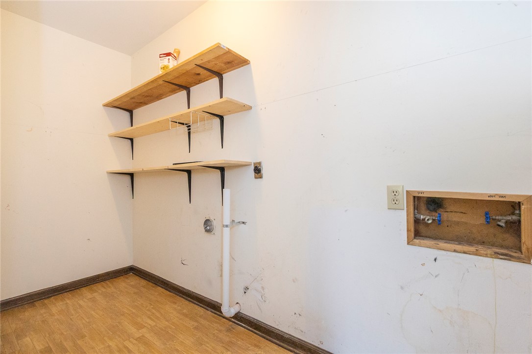 820 Travis Road Anderson, SC 29626 - Photo 25 of 46 This dedicated laundry space offers practical shelving and essential hookups for efficient home management.