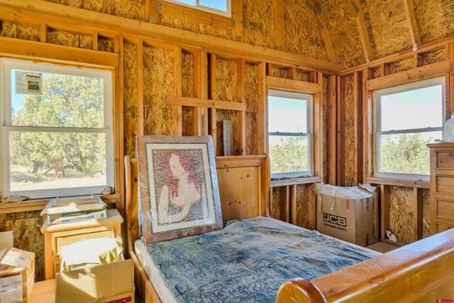 a bedroom with a bed and wooden cabinets