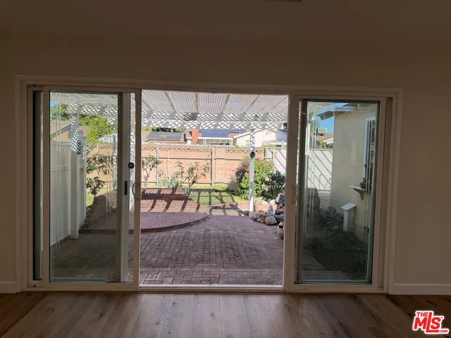 a large kitchen with stainless steel appliances granite countertop a large stove a sink dishwasher and a refrigerator with wooden floor