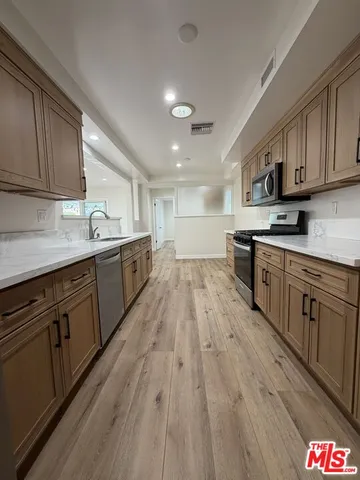 a view of an empty room and wooden floor