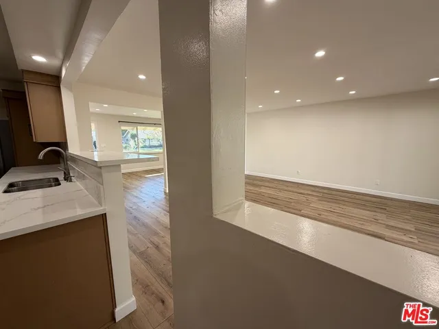 a view of a room with wooden floor