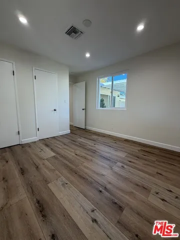 a view of storage and utility room with wooden floor